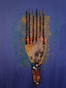 Ebony Beauty Heritage by Serj Éty’n — framed mixed-media artwork displayed in a modern living room, featuring a stylized Afro comb on a deep blue background with textured glitter, dark vertical spikes, and colorful bead details symbolizing Black heritage and identity.