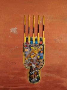 Contemporary mixed-media artwork featuring an abstract Afro hairstyle silhouette made of colorful textured elements on a warm orange background, created by Serj Éty’n. 